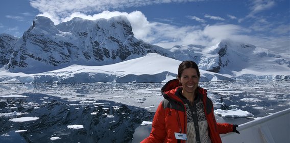 photo of Anne Christianson in front of ice field in Antarctica